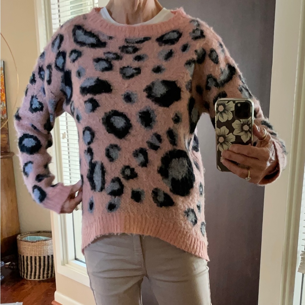 Woman’s animal print pink, black, and gray sweater.